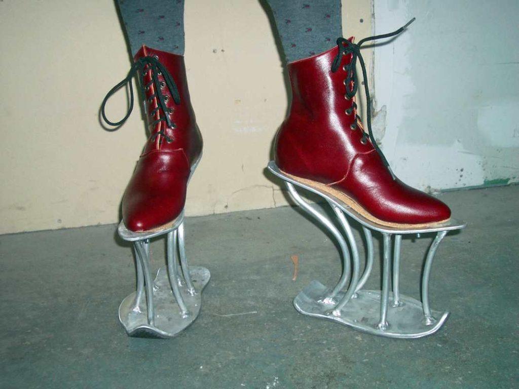 Brown leather shoes on raised metal platform